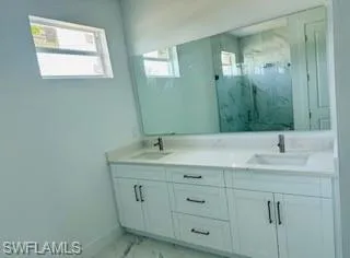 Bathroom with tile patterned flooring and double sink vanity