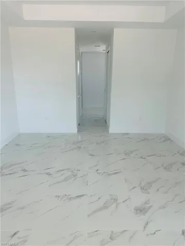 Spare room with light tile floors
