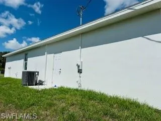 View of side of home featuring central AC unit
