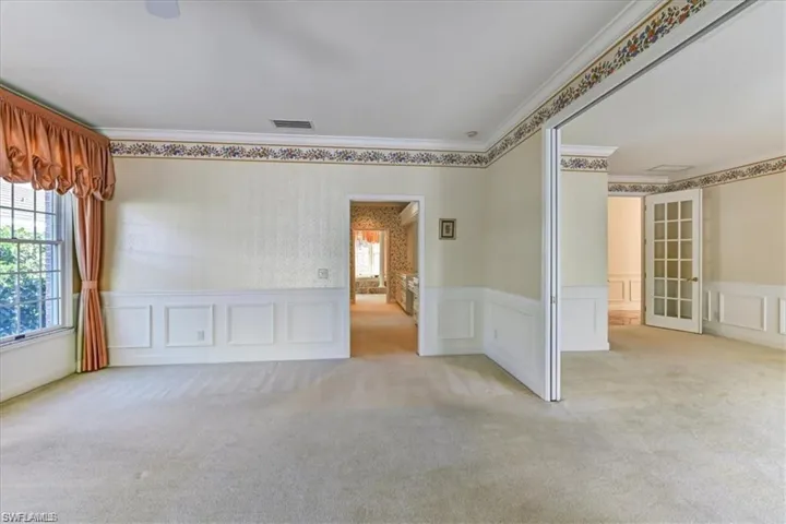 Spare room with carpet and crown molding