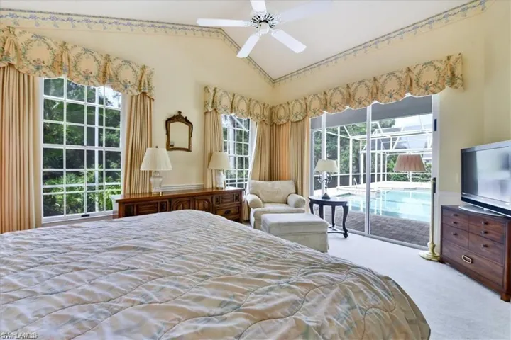 Bedroom with carpet, ceiling fan, access to outside, and high vaulted ceiling
