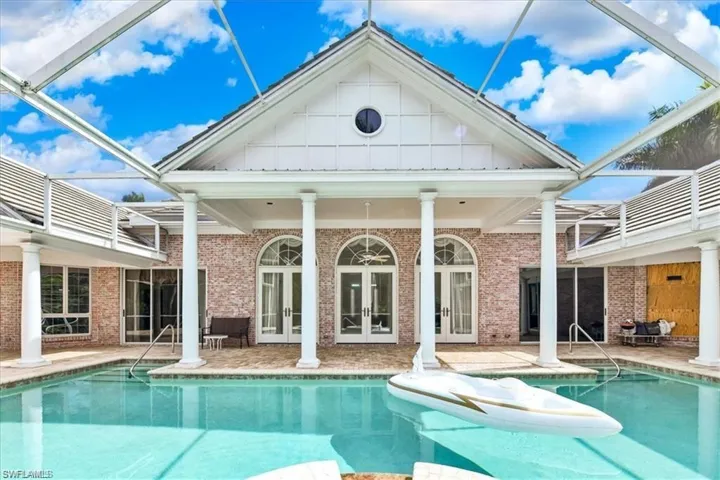 View of pool featuring a patio, a lanai, and french doors