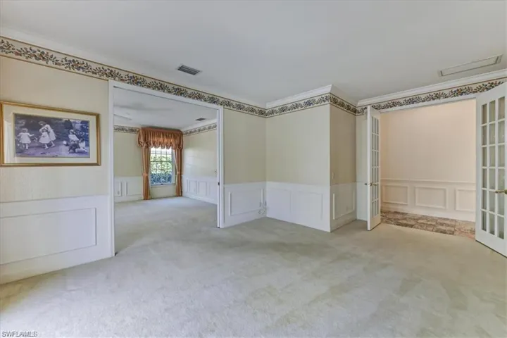 Spare room featuring ornamental molding, carpet floors, and french doors