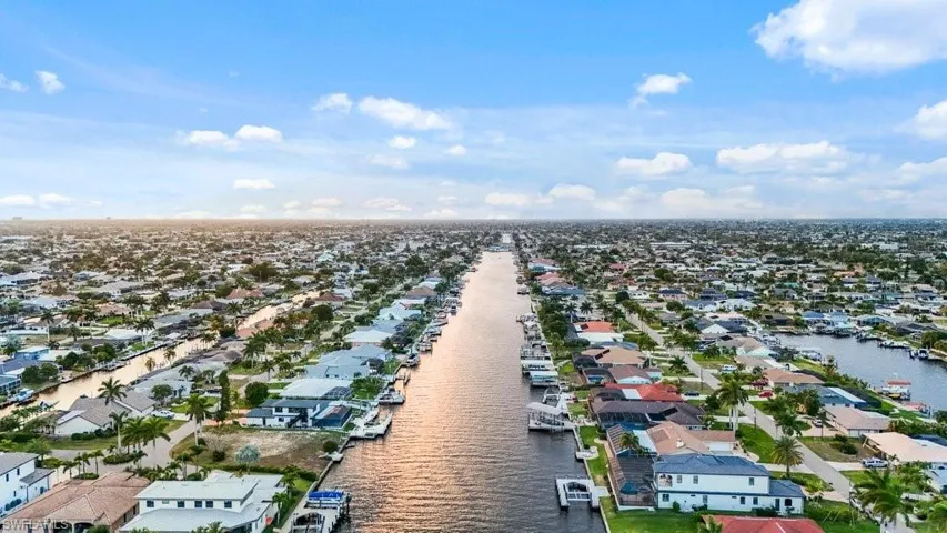Aerial view of residential area featuring a nearby body of water