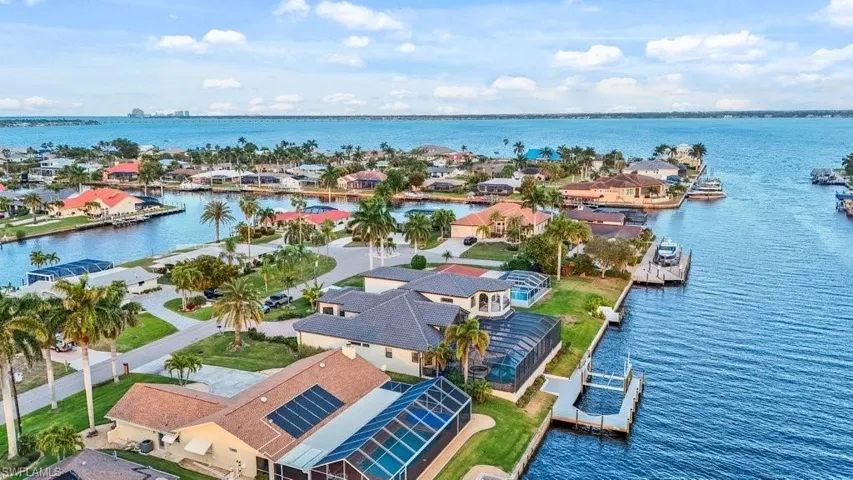 Aerial view of residential area featuring a nearby body of water