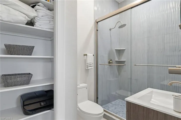 Bathroom featuring vanity and a shower stall