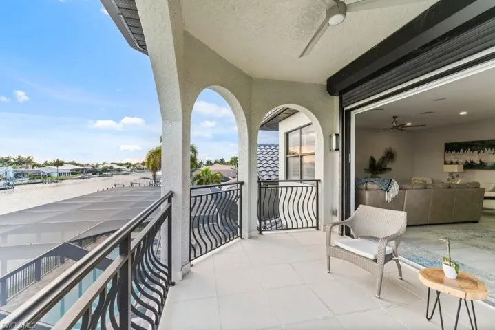 Balcony with ceiling fan and a residential view