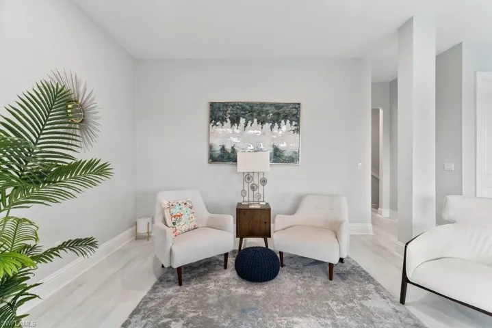 Living area with wood finished floors and baseboards