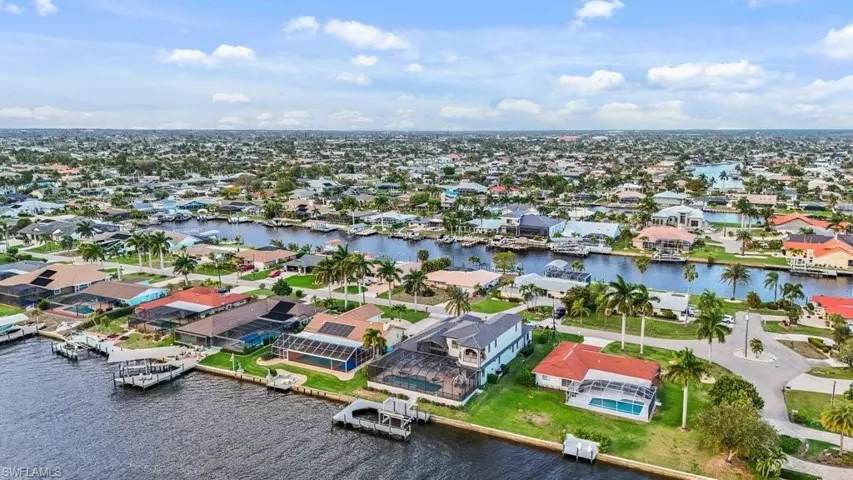 Aerial view of residential area featuring a large body of water