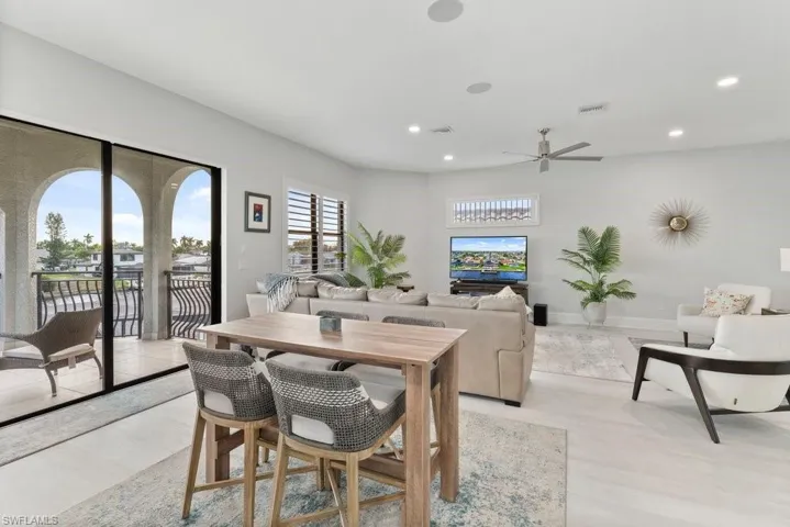 Dining room featuring light wood-style floors, ceiling fan, and recessed lighting