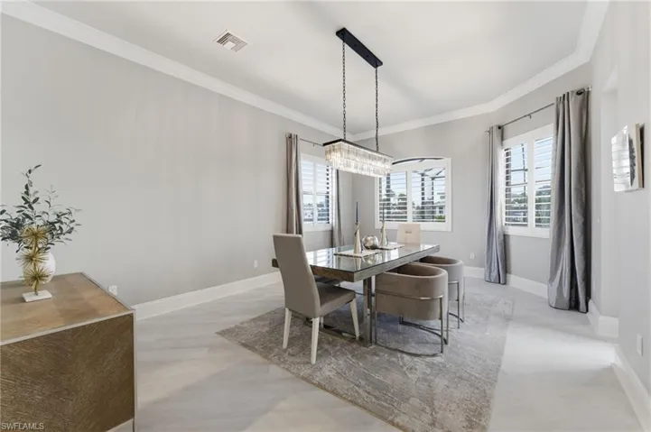 Dining room featuring plenty of natural light and ornamental molding