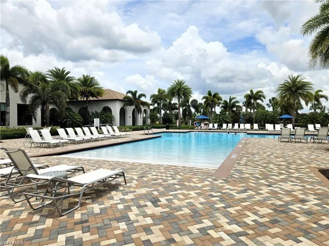 Large outdoor swimming pool with a gradual entry and paver decking