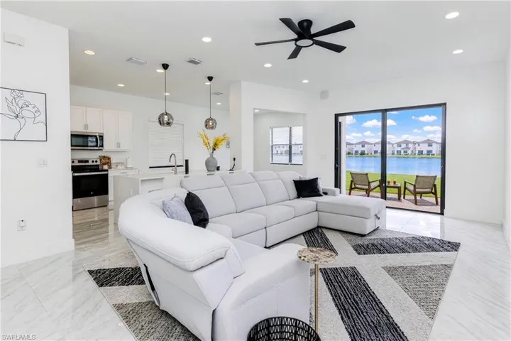 Open-concept living area with tile flooring and recessed lighting