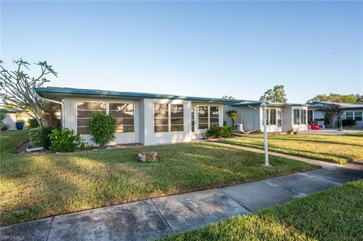 Single story home with a front lawn
