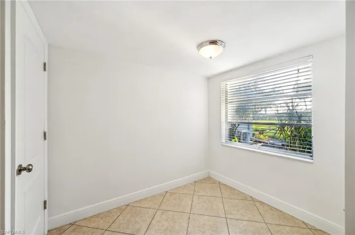 Unfurnished room featuring light tile patterned floors