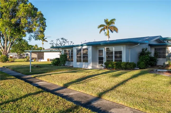 Ranch-style home featuring a front lawn