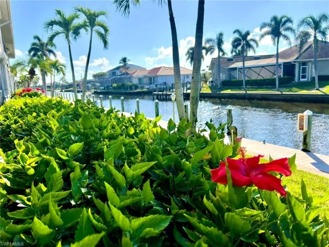 Water view featuring a boat dock and nearby suburban area