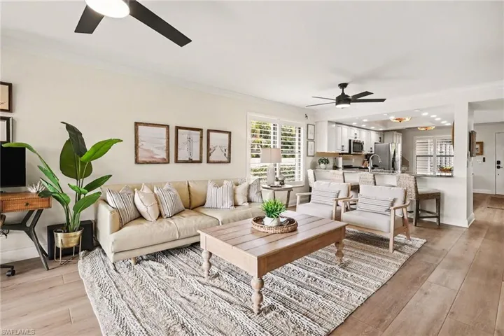Living area featuring a ceiling fan, crown molding, light wood-style flooring, and recessed lighting