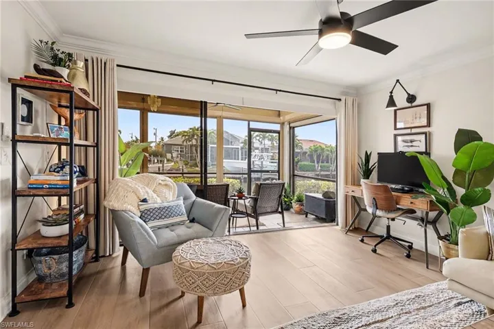Office featuring crown molding, wood finished floors, and a ceiling fan