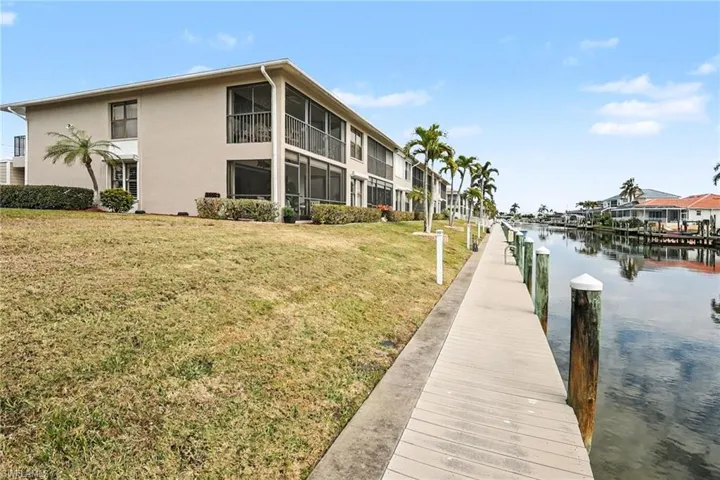 Dock featuring a yard and a water view