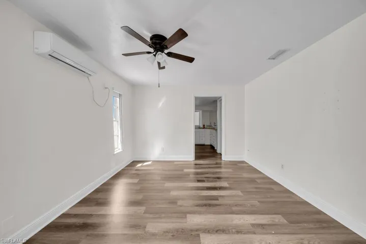 Empty room featuring wood finished floors and ceiling fan