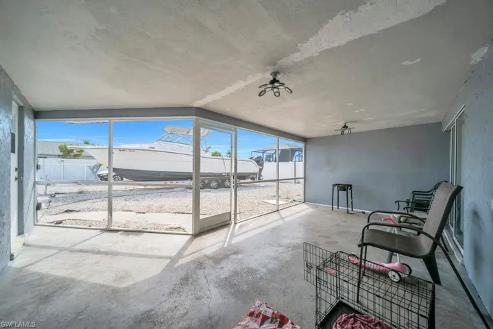 Sunroom / solarium with healthy amount of natural light and ceiling fan