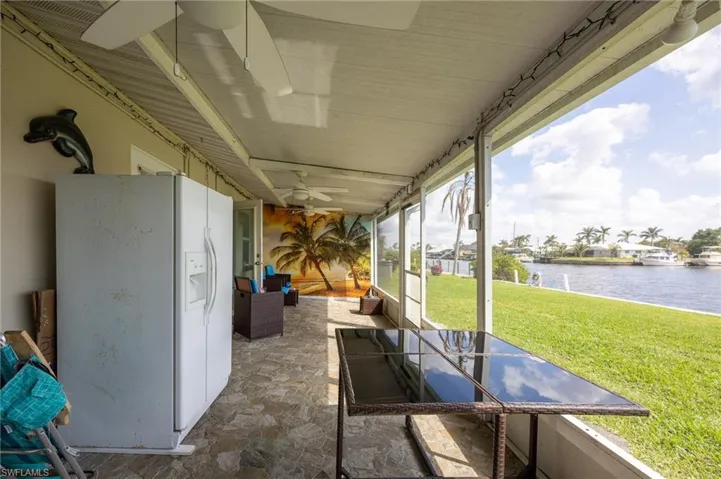 View of patio / terrace with a water view and a ceiling fan