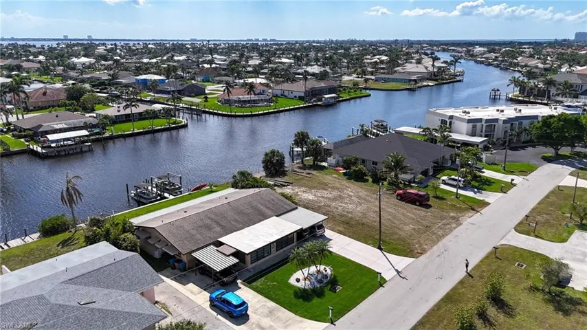 Birds eye view of property featuring a residential view and a water view