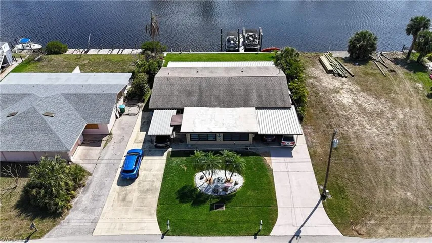 Birds eye view of property with a water view
