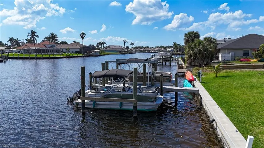 Dock area featuring a yard, a water view, and a residential view