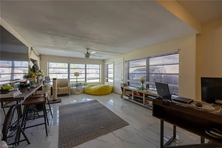 Office space with marble finish floor and ceiling fan