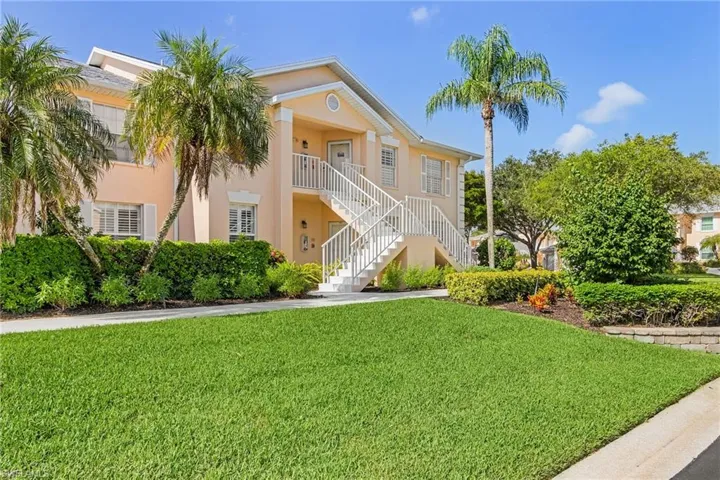 View of property featuring stairs