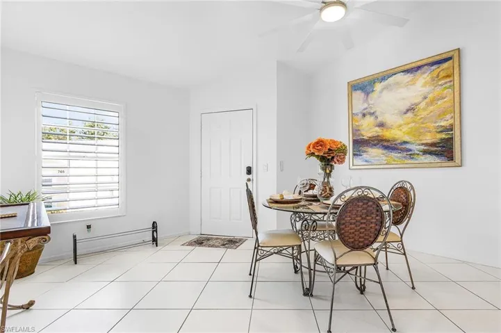 Dining area featuring light tile patterned flooring and a ceiling fan