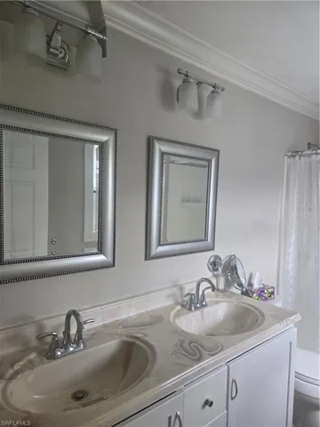Dual vanity with integrated sinks, chrome fixtures, and a white cabinet base