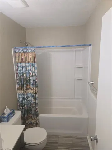 White tub and shower combination with a chrome shower head