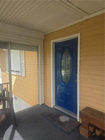 Screened-in porch featuring yellow horizontal siding and white trim