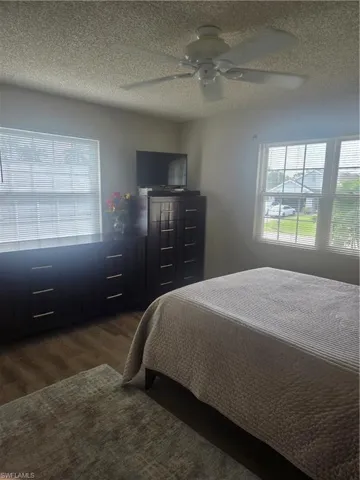 Room with  wood-finish flooring and multiple windows