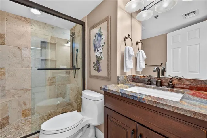 Frameless glass shower enclosure with tile surround and built-in niche