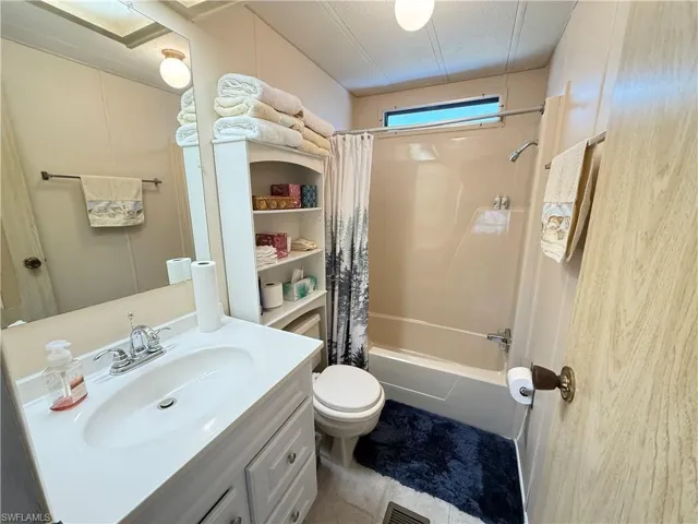 Bathroom featuring shower / bath combo and vanity