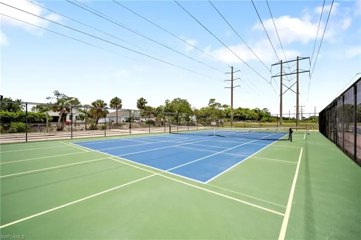 View of tennis court featuring community basketball court