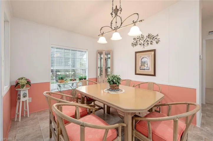 Dining area featuring ornamental molding and an inviting chandelier