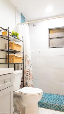 Bathroom with a tile shower and vanity