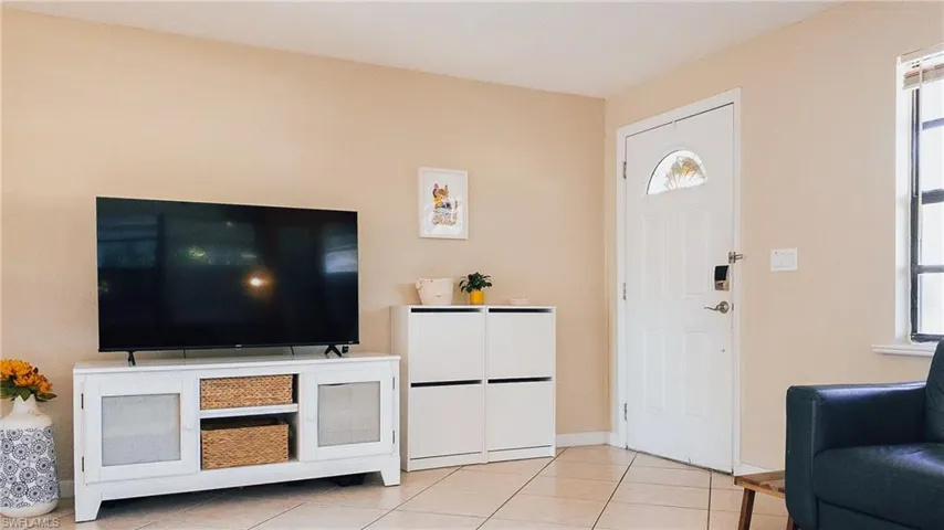 Entryway featuring light tile patterned floors and healthy amount of natural light