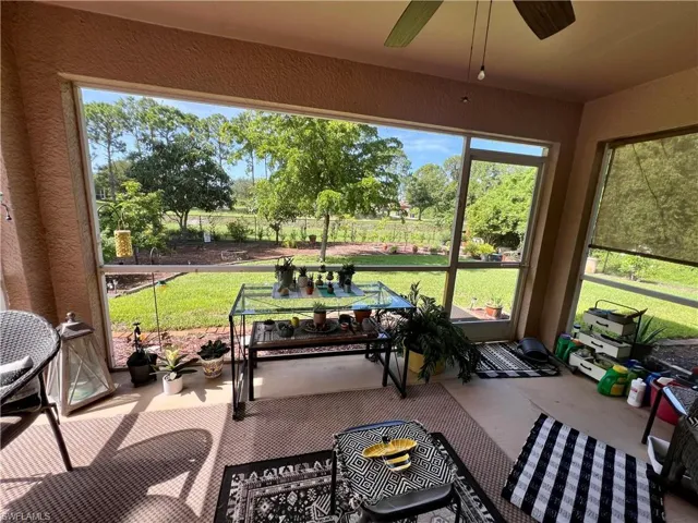 Sunroom featuring plenty of natural light and ceiling fan
