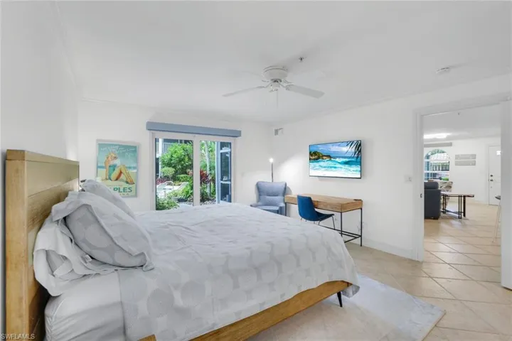 Bedroom with a ceiling fan, light tile patterned flooring, access to exterior, and crown molding
