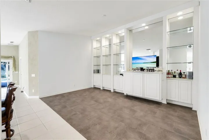 Unfurnished living room featuring light tile patterned floors and built in features