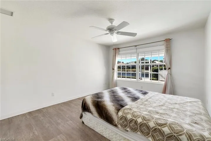 Bedroom featuring wood finished floors, ceiling fan, and a textured ceiling