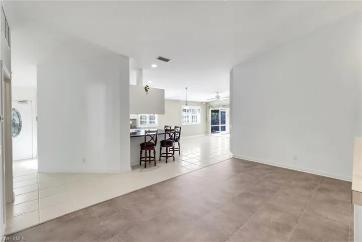Unfurnished room featuring a ceiling fan and light tile patterned floors