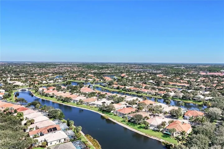 Aerial view of residential area featuring a nearby body of water