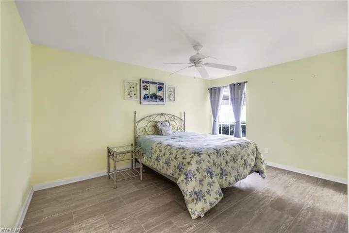 Bedroom featuring wood finish floors and ceiling fan
